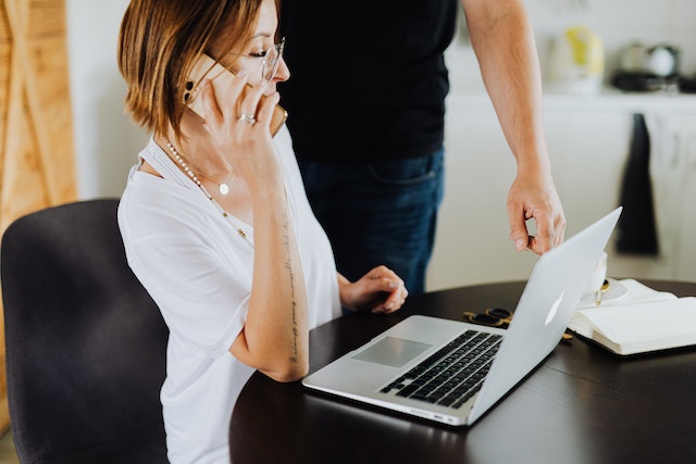 person sharing the travel plans with someone in-person and over the phone